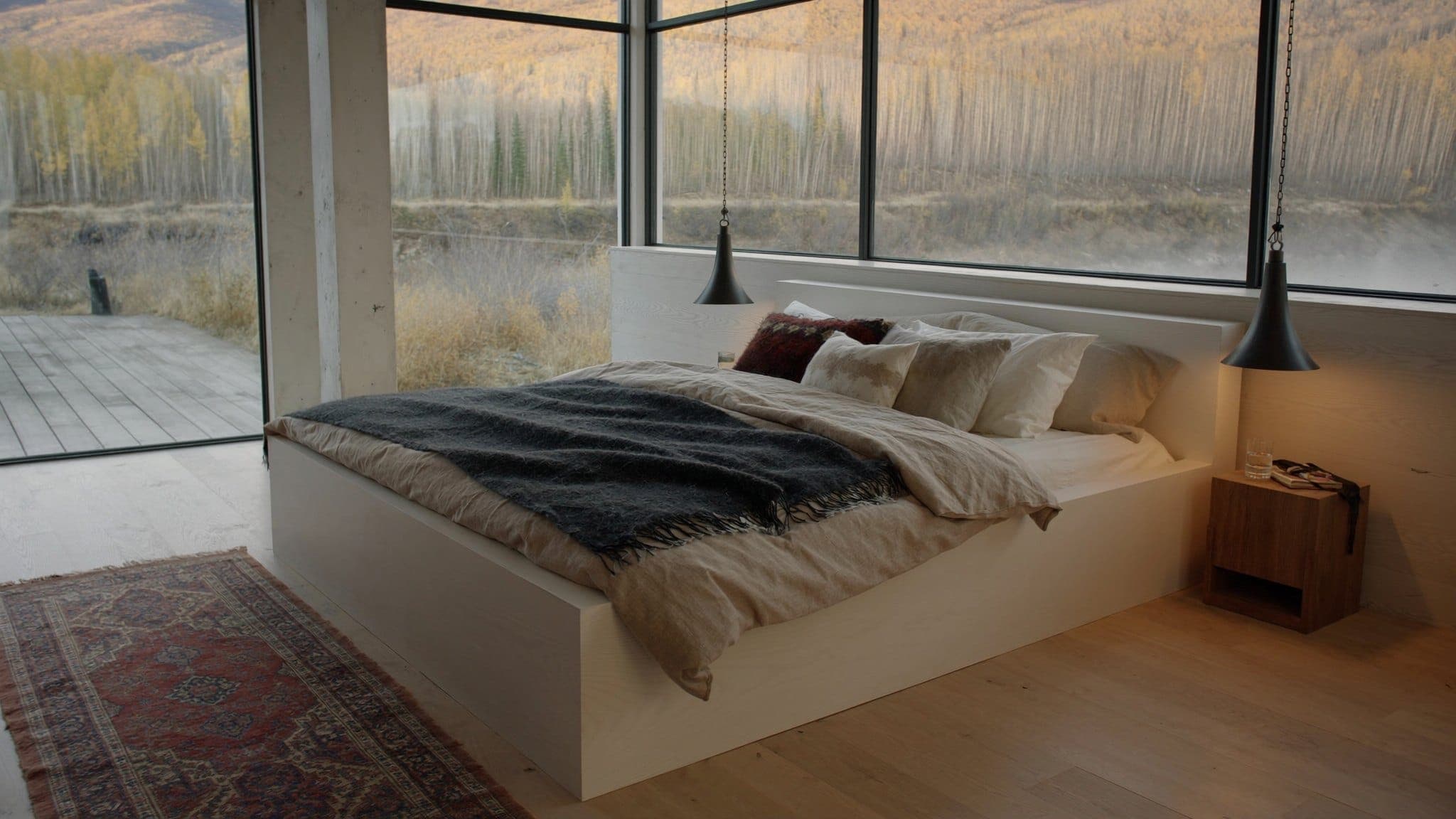 Render: primary bedroom with cedar accent wall and east-facing glazing